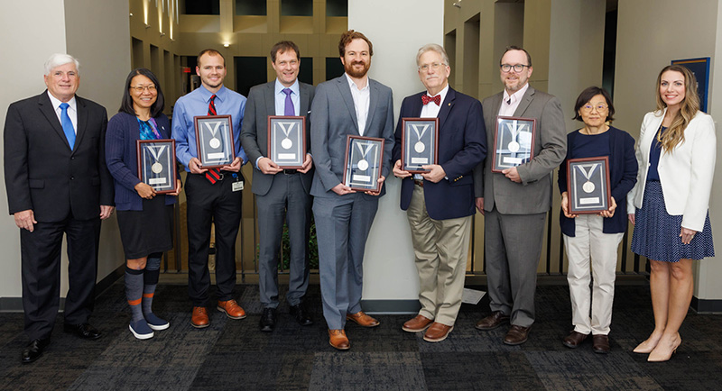 Dr. Eric Vallender and Dr. Harry Pantazopoulos receive the Silver Medallion.